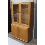 An Ercol blonde elm cabinet. Condition - light scratches to top of bottom cabinet, otherwise ok,