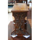 A carved oak stool, carved in the manner of Arthur Simpson, length 62.5cm, depth 26cm & height 48cm.