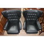 A pair of 'Blofeld' style black rexene retro swivel armchairs with arched buttoned wing back above