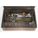 An old watch and clock maker's lathe, fitted in box with accessories.