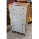 A G-Plan light oak and painted tall chest of drawers with brass knobs and black base, width 60.