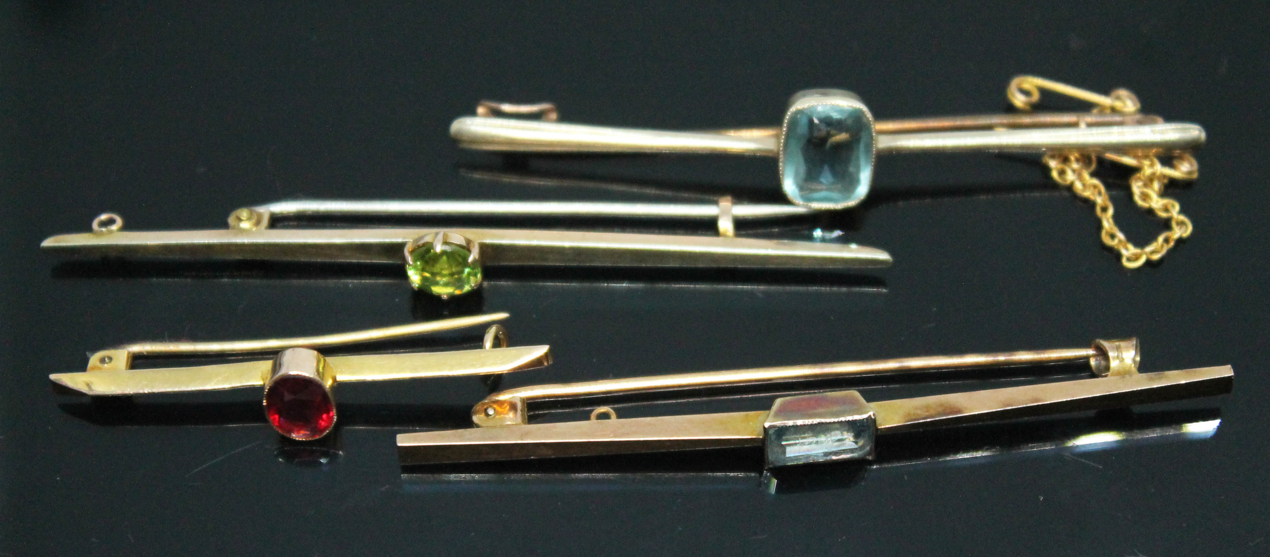 A group of four bar brooches, each set with coloured paste, all marked '9ct', gross wt. 9.04g,