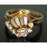 A diamond cluster combination ring, the central mdoern round brilliant cut diamond weighing