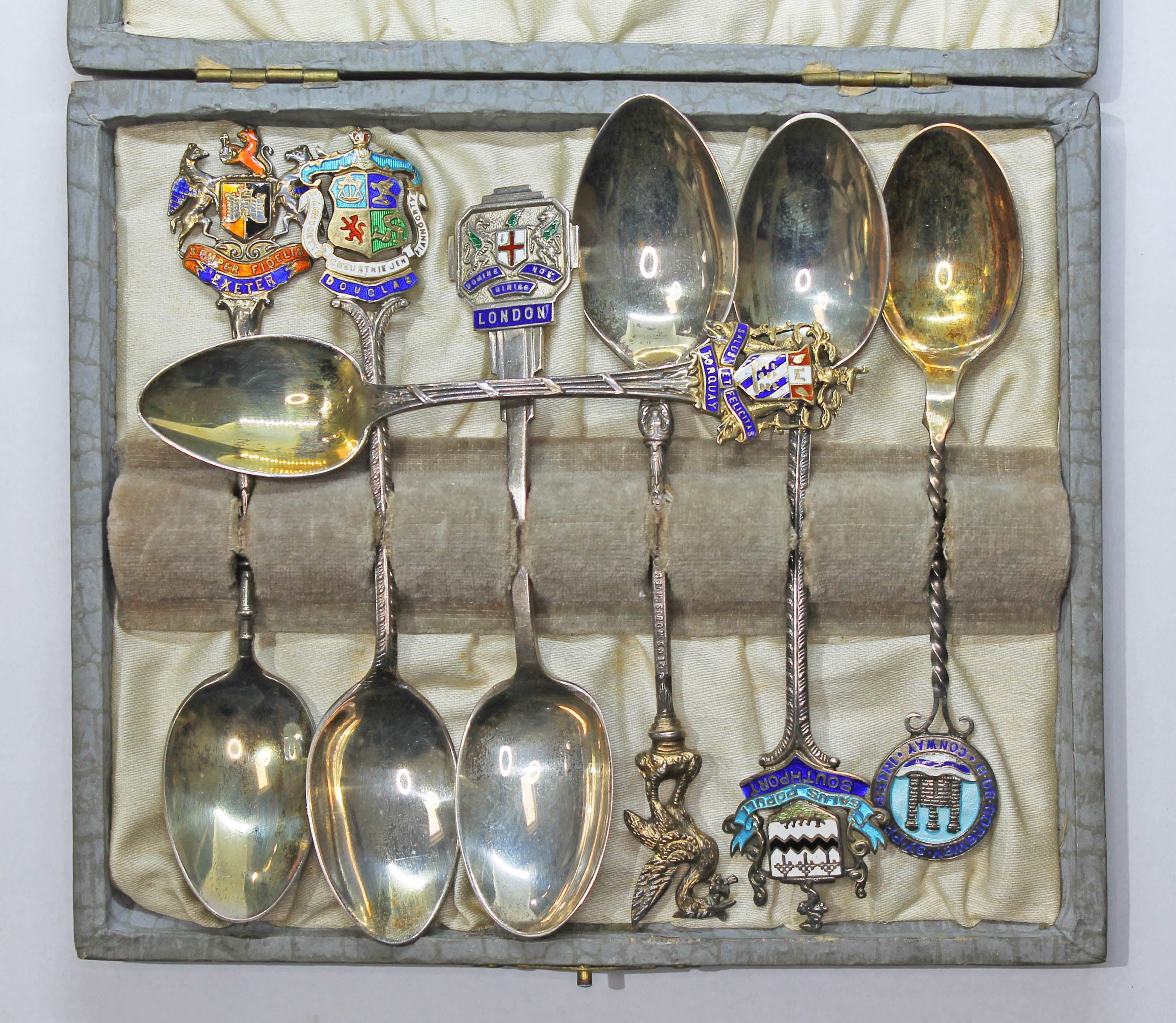 A case containing seven hallmarked silver souvenir teaspoons. Condition - general wear.