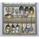 A case containing seven hallmarked silver souvenir teaspoons. Condition - general wear.