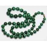 A vintage graduated single strand of malachite beads, ranging in diameter from 10mm to 15mm,