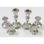 Three pairs of hallmarked silver candlesticks, heights 6cm to 13cm. Condition - ding to rim of