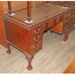 An Edwardian Chippendale style mahogany knee hole desk with cedar lined drawers, width 125cm,