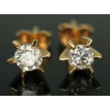 A pair of diamond solitaire stud earrings, each with a six claw set modern round brilliant cut