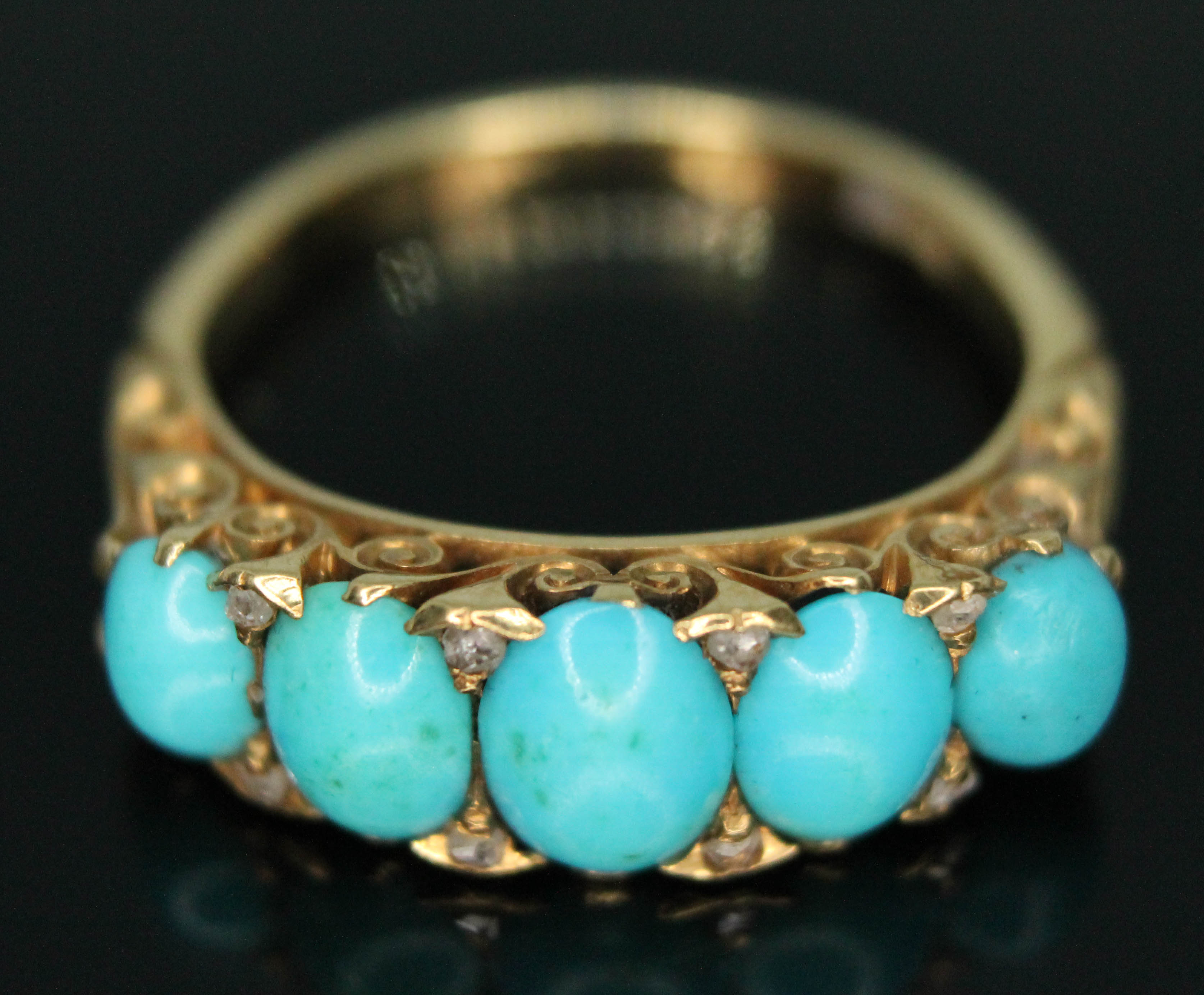 A Victorian turquoise and diamond ring, scroll setting, marked '18c', gross wt. 4.83g, size N.