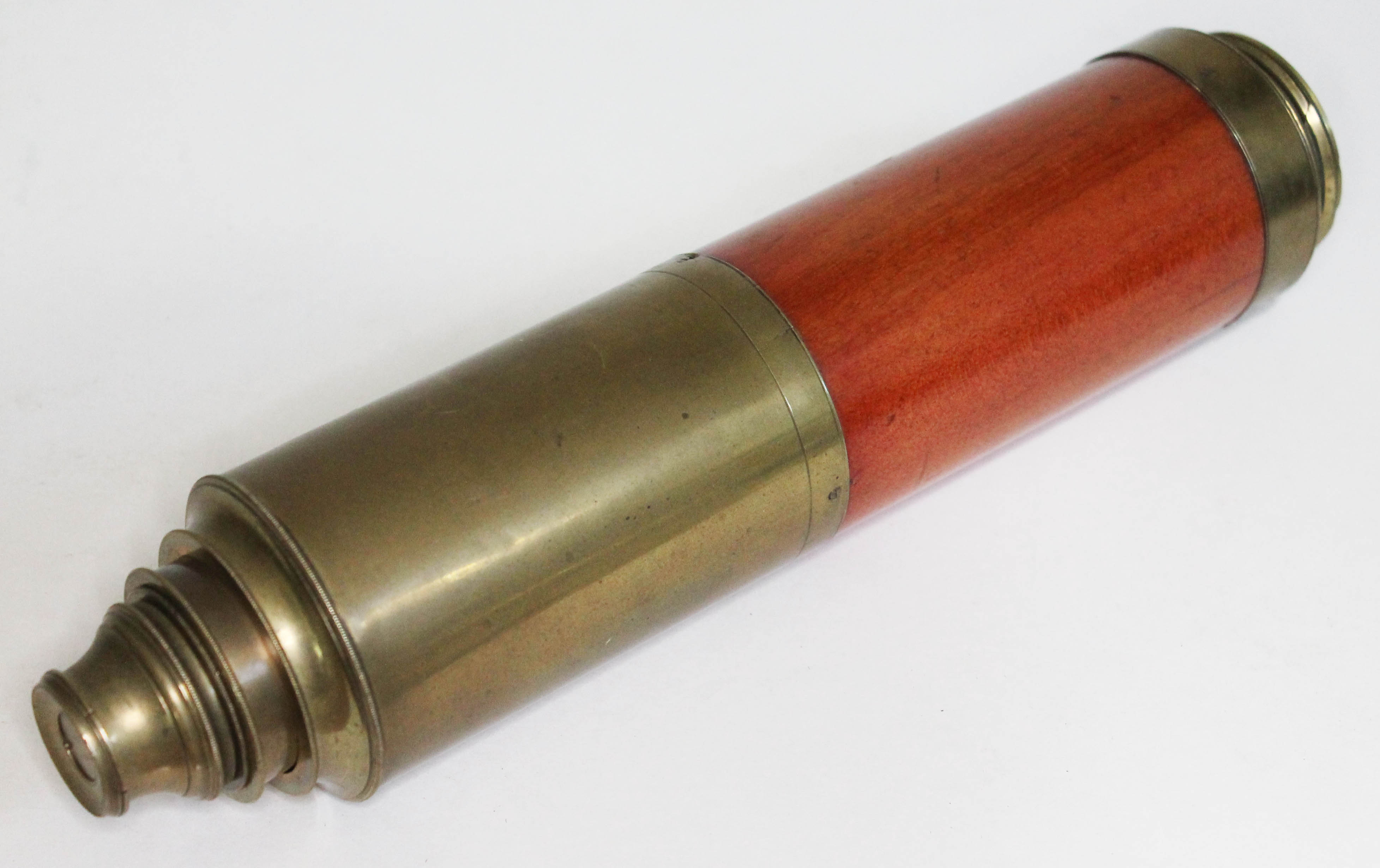 A three drawer wooden bound brass telescope.