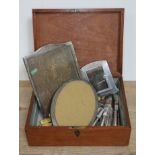 A mahogany box containing two hall hallmarked silver framed photograph frames and a card holder,