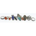 A group of ten white metal rings, some marked '925', various settings including amber, lapis, onyx