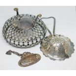 Three items of hallmarked silver comprising a tea strainer, a Whisky decanter label and a pierced