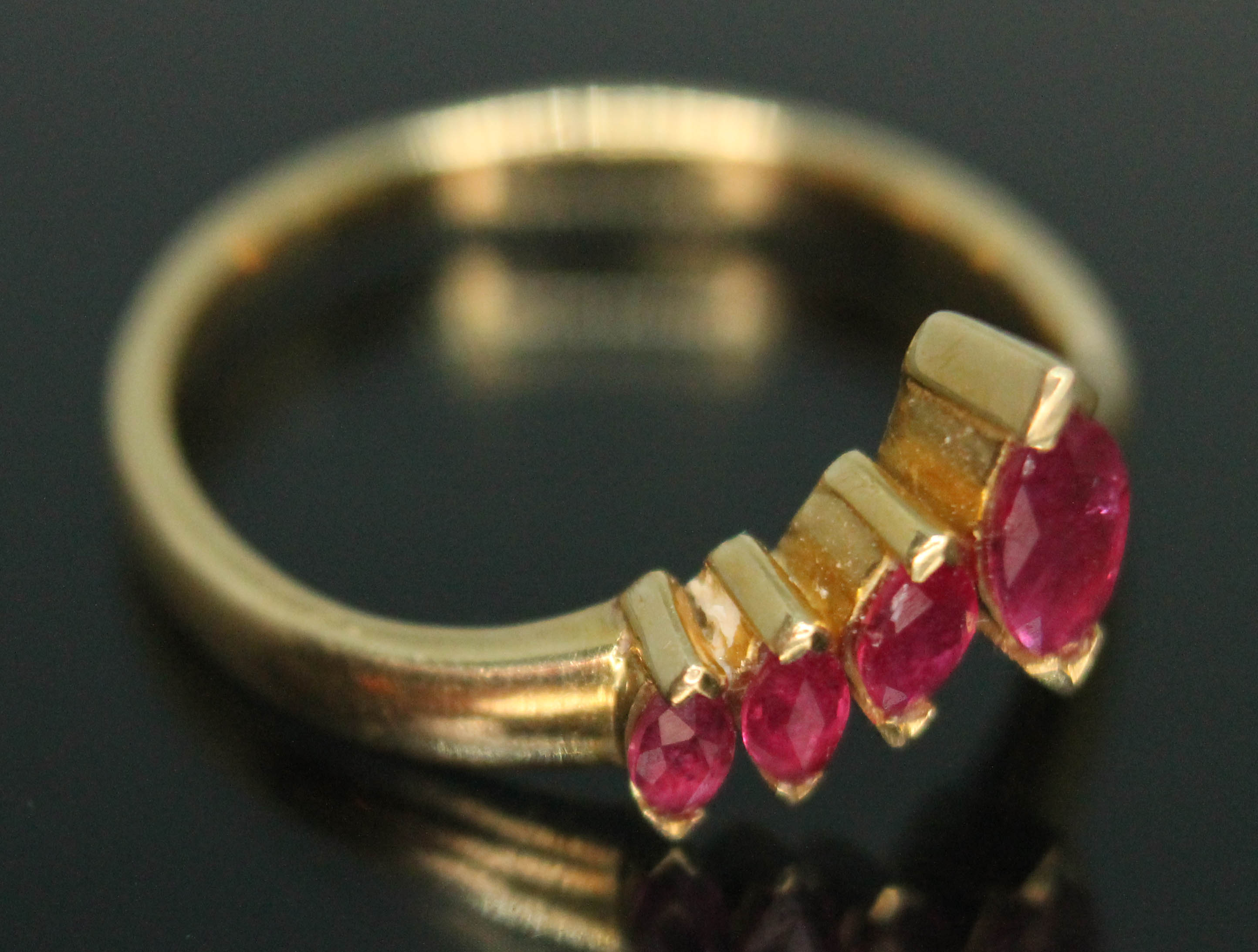 A wishbone ring set with four marquis cut rubies, band marked '750', gross wt. 2.82g, size L/M.