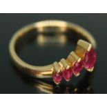 A wishbone ring set with four marquis cut rubies, band marked '750', gross wt. 2.82g, size L/M.