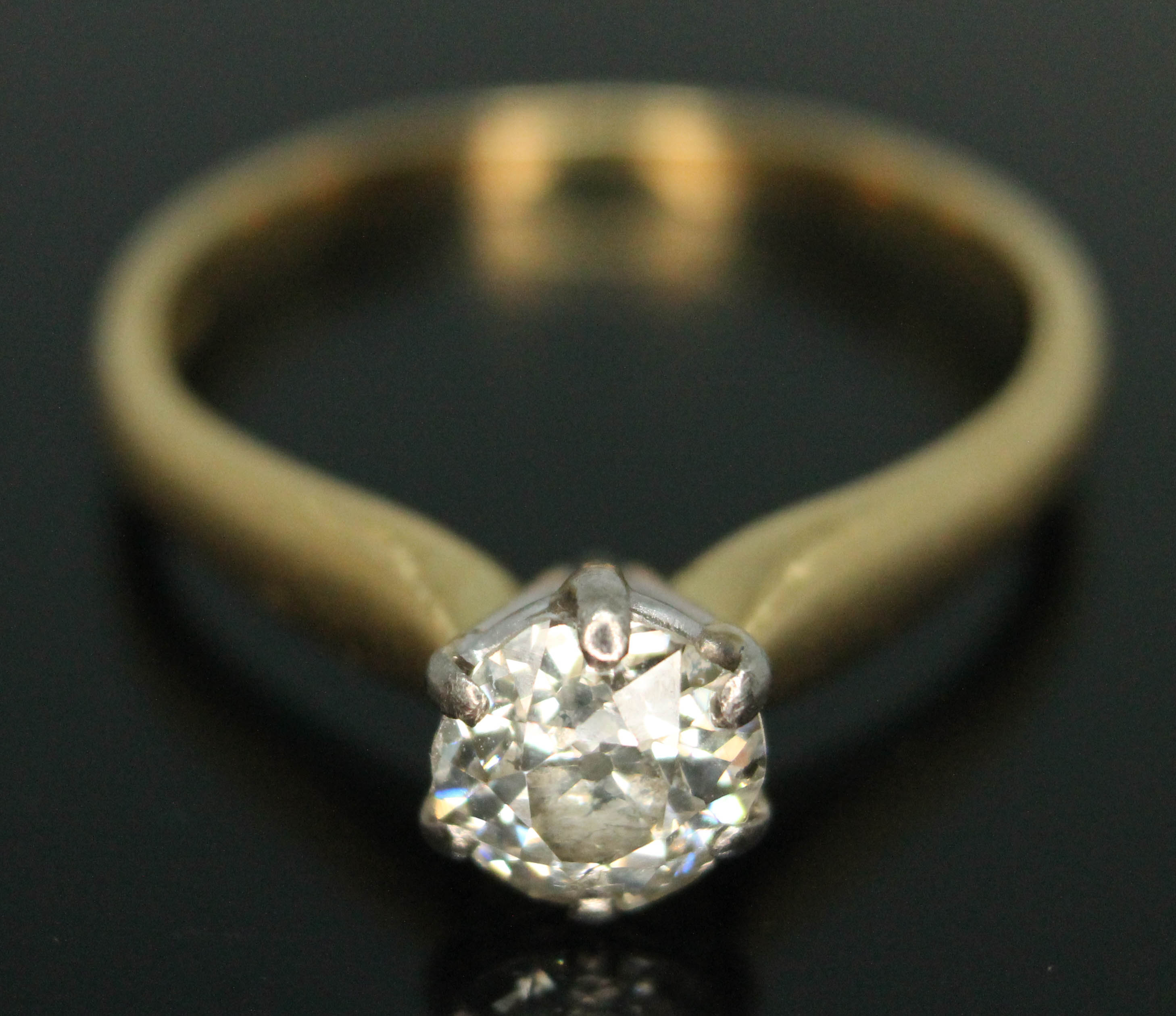 A diamond solitaire ring, the six claw set old European slightly oval cut stone weighing approx. 1.