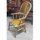 A 19th century elm Windsor chair, width 62cm, depth 69cm & height 115cm.
