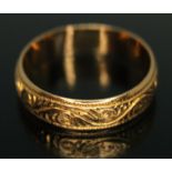 A 22ct gold engraved wedding band, sponsor's initials 'SH', Birmingham 1925, wt. 4.71g, size Q/R.