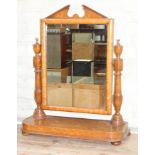 A 19th century bird's eye maple toilet mirror with architectural cornice, turned supports and
