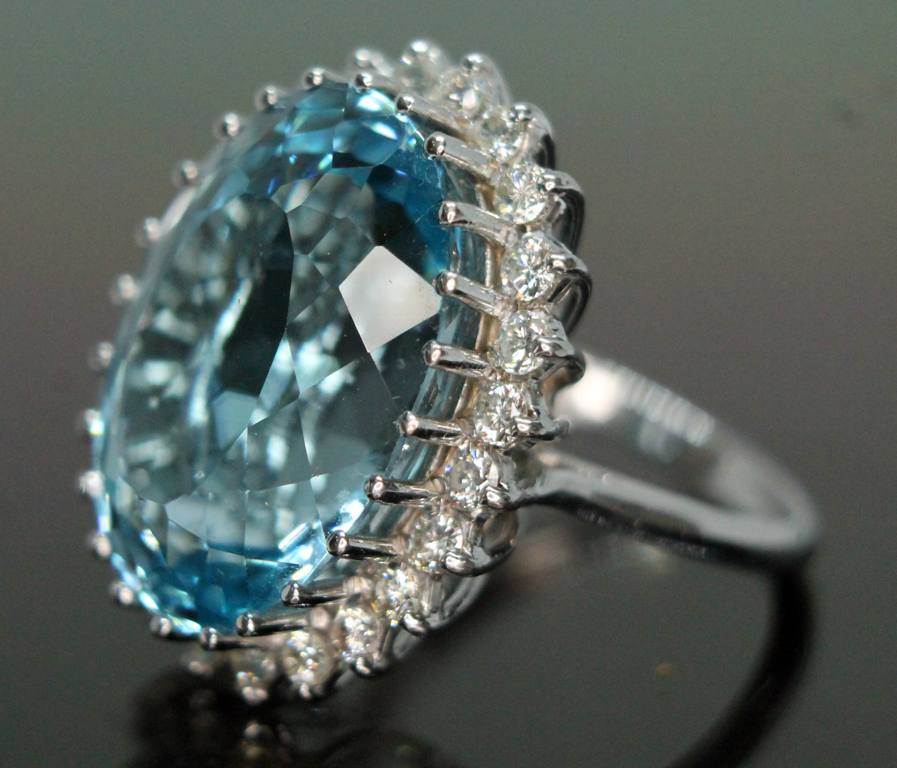 A topaz and diamond cocktail ring, the light to medium oval mixed cut blue topaz weighing approx.