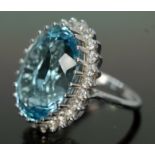 A topaz and diamond cocktail ring, the light to medium oval mixed cut blue topaz weighing approx.