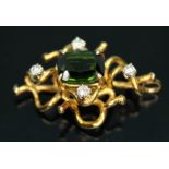 An 18ct gold diamond and tourmaline pendant of random wire form, the central rectangular cut green