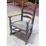 A 19th century child's rush seated ladder back rocking chair.