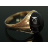 A garnet cabochon signet ring, the garnet measuring approx. 13mm x 10cm x 5mm, sponsor's mark '