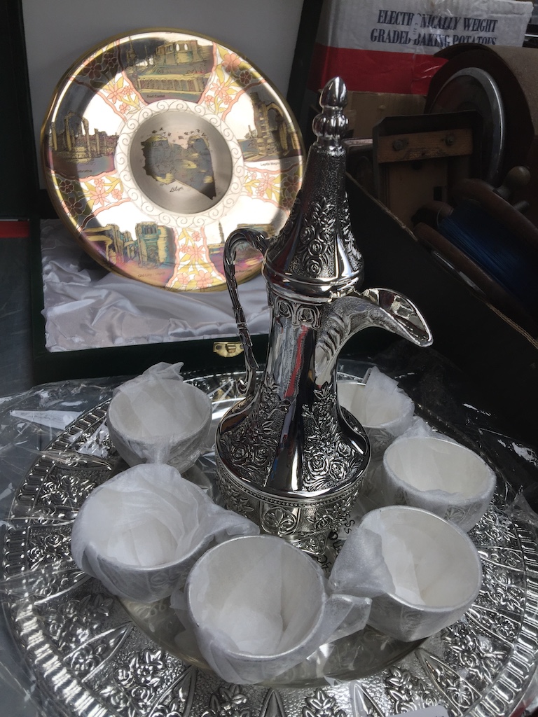 White metal Arabic tea set and an etched metal wall plate depicting Roman archeological sites in