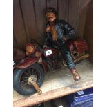 A model of a motorcycle rider on vintage Harley Davidson.
