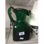 A green glass heavy jug