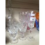 A crystal decanter with 4 Doulton wine glasses and 4 Royal Albert flutes