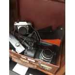 A vintage briefcase containing some cameras and accessories to include 2 X Ihagee EXA IIb, MF5000,