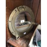 A replica brass mounth porthole mirror