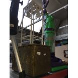 A brass bound coal bucket and a metal plant stand.