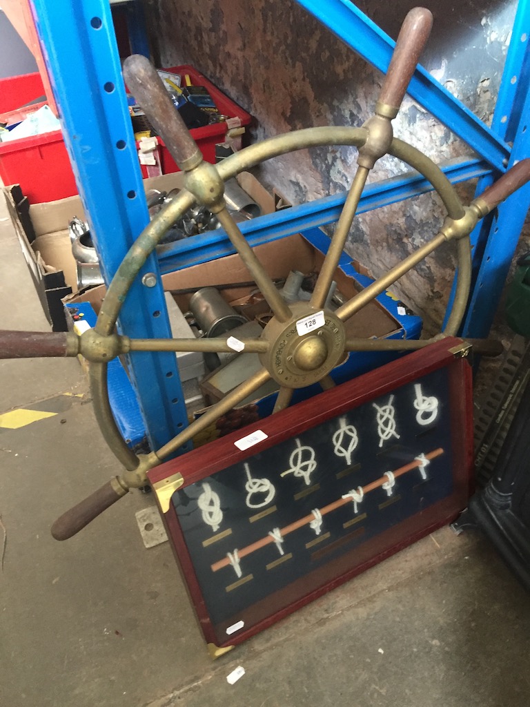 A brass ship's wheel and a knot display