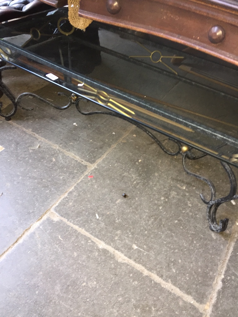 A wrought metal and glass coffee table