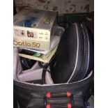 A camera bag with contents, to include cameras, accessories, docking station, etc.