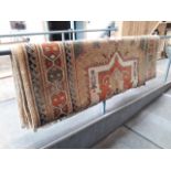 A large beige ground woven eastern rug, 197cm x 290cm.