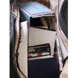 A holdall containing various books, programmes, etc.