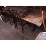 A large oak two plank and cleated end refectory table together with eight spindle back chairs