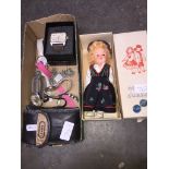 A box of watches. a Norske Dukker doll and a Canon camera