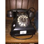 A vintage black bakelite GPO telephone.