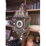 A vintage Nu Elck Syn Sin Dutch wall clock with weights and pendulum.