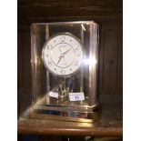 A Seiko quartz revolving pendulum clock