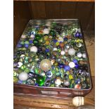 A tin of approx 200+ vintage marbles.