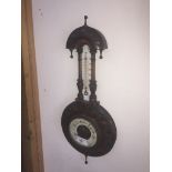 A late Victorian carved mahogany cased barometer.