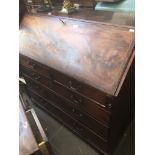 A Georgian inlaid mahogany bureau with shell inlaid interior and tooled green leather writing