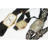 Three early 20th century Art Deco manual wind ladies wristwatches comprising an engraved silver